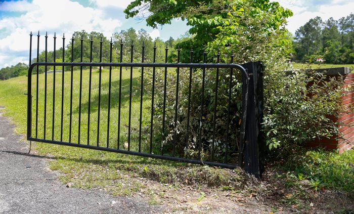 Iron gate and fencing along the cemetery boundary